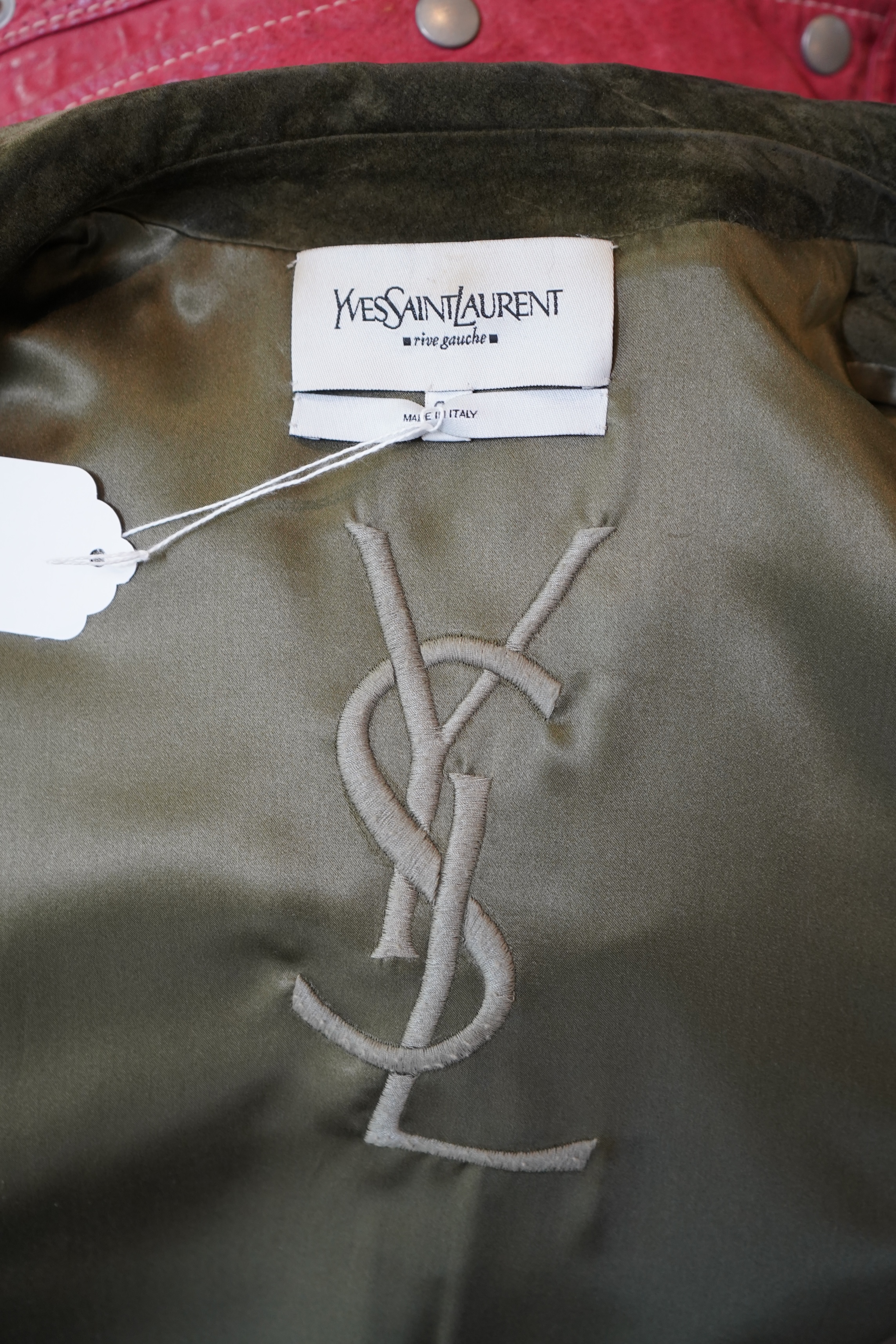 A lady's Yves Saint Laurent olive green suede jacket with stitching details and a black YSL (label missing) gypsy skirt with underskirt. IT 38 (UK size 10)